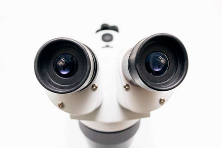 Large metal microscope on a white background close up