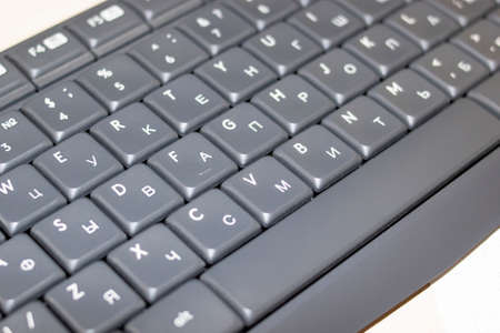 Keys on a gray keyboard close up on wooden table
