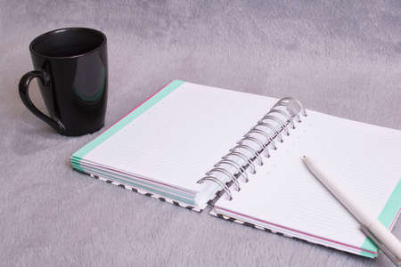 Pen, blanket and a cup of coffee close up