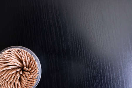 Toothpicks in glass top view on wooden table, copy spaceの写真素材