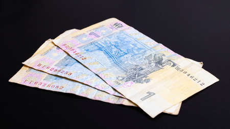 Three banknotes of Ukrainian hryvnia on a black background close upの写真素材