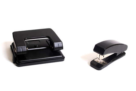 Black hole punch and stapler isolated on white background close upの写真素材