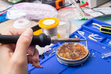 Soldering iron tip and yellow rosin closeupの写真素材