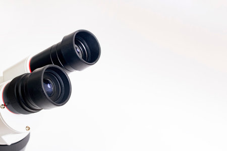Gray medical microscope on a white background, copy spaceの写真素材