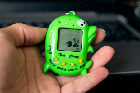 BELARUS, NOVOPOLOTSK - 03 MAY, 2021: Two tamagotchi toys on laptop keyboard close up