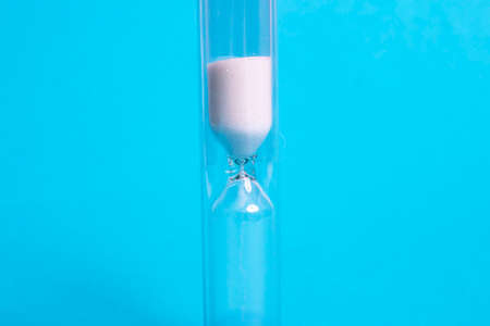 Medical hourglass on a blue background close up