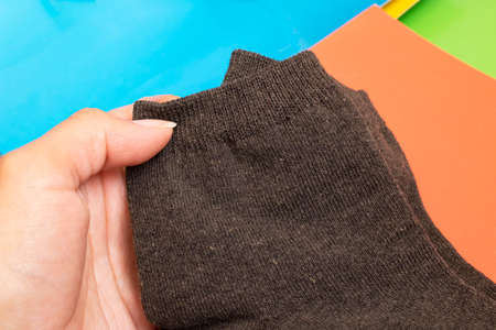 Pair of gray socks in hand close upの写真素材