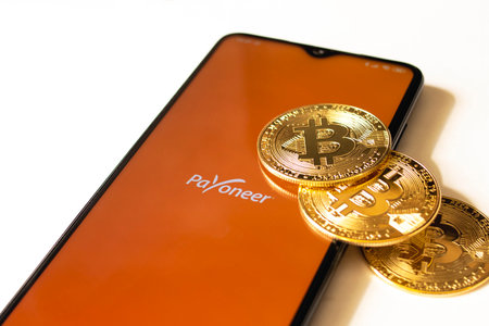 BELARUS, NOVOPOLOTSK -16 MAY, 2021: Phone payoneer app and bitcoins close upのeditorial素材