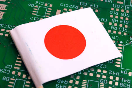 Japan flag on green circuit board background close upの写真素材