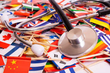 Stethoscope on the background of flags of different countries close upの写真素材