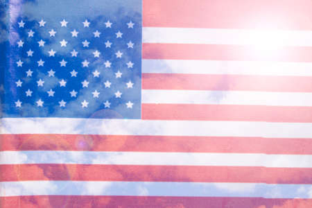 American flag on a blue sky background close upの写真素材