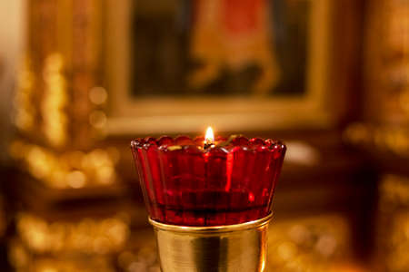 One candle on a stand in a church close upの写真素材