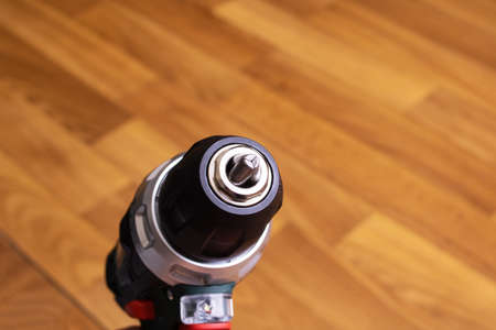 Red screwdriver on a wooden background close up