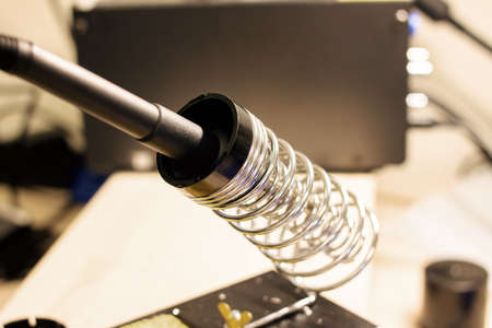 Soldering iron in a metal stand close upの写真素材