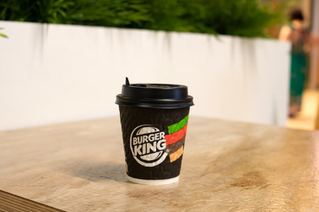 BELARUS, NOVOPOLOTSK - 02 JULE, 2021: Paper cup of coffee with Burger King logo on tableのeditorial素材