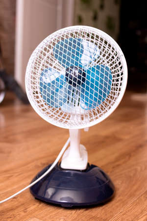 Small indoor fan on the background of the room