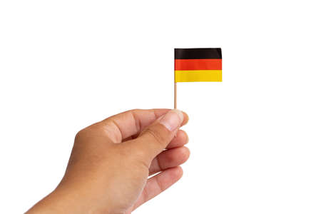 Small germany flag in hand isolated on white background close upの写真素材