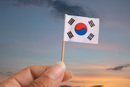 Small Korean flag in hand isolated on white background close upの写真素材