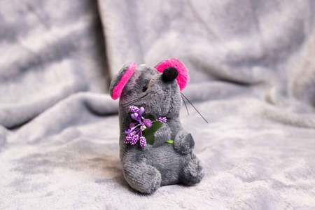 Plush toy gray mouse on gray background close upの写真素材