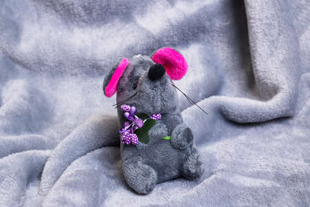 Plush toy gray mouse on gray background close upの写真素材