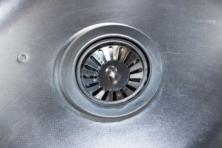 Metal kitchen sink and faucet close up