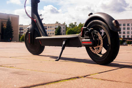 Electric scooter on the background of the city close upの写真素材