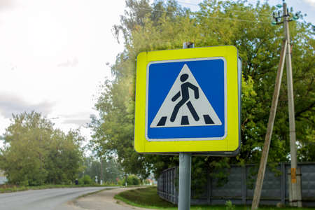 Pedestrian crossing sign near the road close upの写真素材