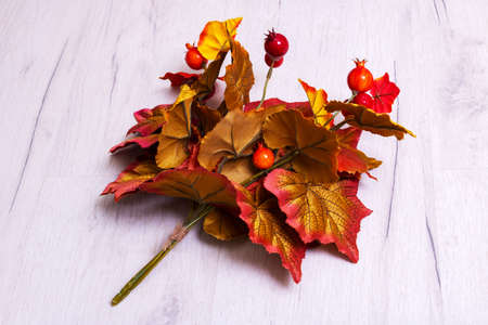 Bouquet of autumn leaves and berries on wooden background close upの写真素材
