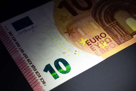 Stack of 10 euro bills in the dark close upの写真素材