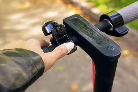 Electric scooter steering wheel on a green forest background close upの写真素材