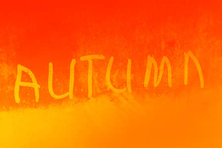 Inscription autumn on a wet glass close upの写真素材