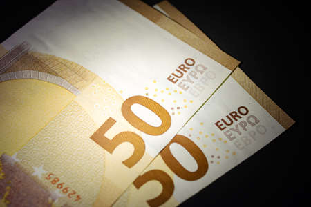 Stack of 50 euro bills in the dark close upの写真素材