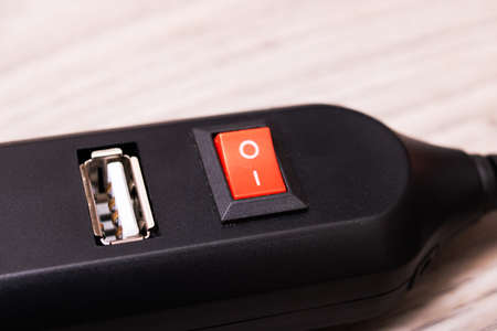 Black USB hub on a wooden background close upの写真素材