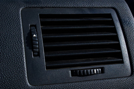 Stove hole in black car interior close up