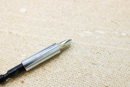 Gray Phillips screwdriver close up on wooden background macro photoの写真素材