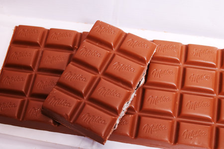 BELARUS, NOVOPOLOTSK - 20 OCTOBER, 2021: Big Milka chocolate bar on a wooden tableのeditorial素材