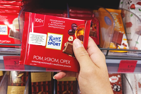 BELARUS, NOVOPOLOTSK - 02 NOVEMBER, 2021: Chocolate Ritter Sport in hand in store close upのeditorial素材