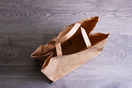 Paper bag on wooden floor close up top viewの写真素材