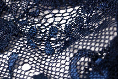 Lace flowers on a blue fabric closeupの写真素材