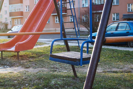 Old childrens swing in the courtyard closeup