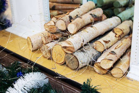 Logs of firewood in a decorative fireplace close up