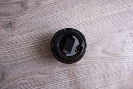 Paper cup with coffee on wooden background close upの写真素材