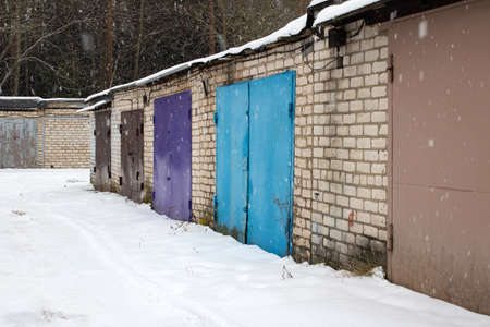Garage doors in a row in the snow close upの写真素材