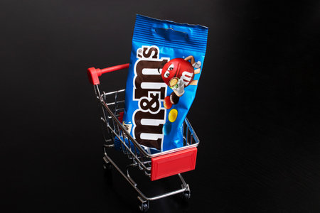 Belarus, Novopolotsk - 03 january, 2022: Blue pack of MM in shopping cart close up