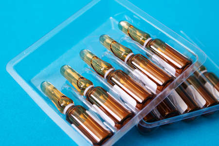 Ampoules with medicine on a blue background close upの写真素材
