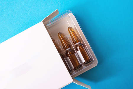 Ampoules with medicine on a blue background close upの写真素材