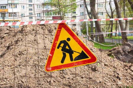 Roadworks, under construction. earthwork sign on fence close up