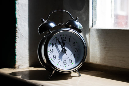 Alarm clock in sunlight on the windowsill