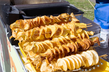Fried potatoes on a stick, street food trade