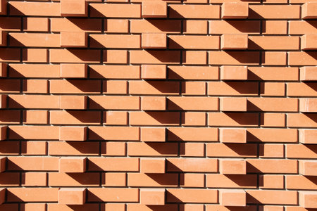 Wall of red brickwork with shade close upの写真素材